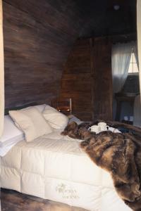 a dog laying on a bed in a bedroom at Dormire in una Botte in Angri