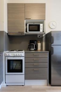 a kitchen with a white oven and a microwave at Studio apartment in central Turku in Turku