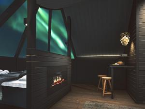 a bedroom with a fireplace with a bed and a table at Apukka Resort in Rovaniemi