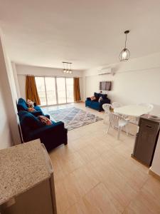 sala de estar con sofá azul y mesa en شاليه فندقى سياحى, en Ain Sokhna
