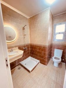 a bathroom with a toilet and a sink at شاليه فندقى سياحى in Ain Sokhna