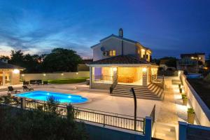 a home with a swimming pool and a house at Villa Relax in Gornji Zemunik