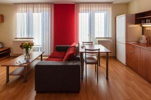 a living room with a couch and a table at Urpí­n City Residence in Banská Bystrica