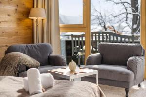 a living room with two chairs and a table at Casa Hirsch - Zentral, Bergblick, TV, Nespresso in Miesbach +15 photos