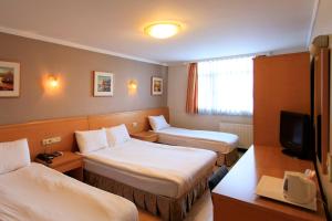 a hotel room with two beds and a tv at Hotel Inter Istanbul in Istanbul +29 photos
