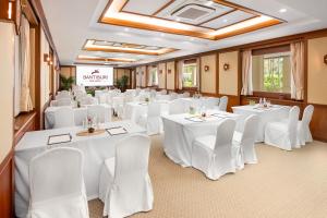 a banquet room with white tables and white chairs at Santiburi Koh Samui in Mae Nam +85 photos