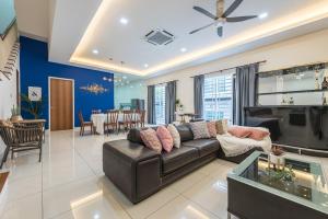 a living room with a couch and a dining room at 5Bedroom Villa @ Seremban 20pax Netflix Projector Pool in Seremban