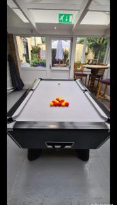 a pool table with balls on top of it at The Bold Arms Hotel in Beaumaris
