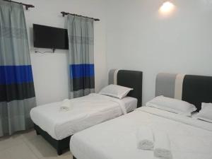 Postel nebo postele na pokoji v ubytování Bayu Laut Resort