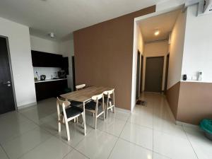 a kitchen with a wooden table and chairs in a room at Traders Garden , cheras Trader square 3 bedroom Balakong serdang in Cheras