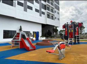a playground in front of a building with playground equipment at Traders Garden , cheras Trader square 3 bedroom Balakong serdang in Cheras