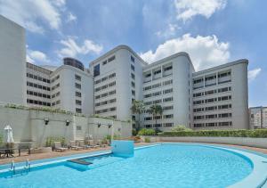 a swimming pool in front of a large building at ILLUME Taipei in Taipei