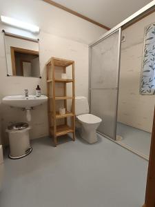 a bathroom with a sink and a toilet and a shower at Fossanmoen in Forsand