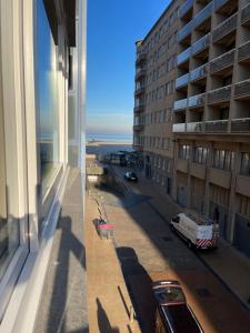 a view of a city street from a building at Logies Windsor One Room in Ostend