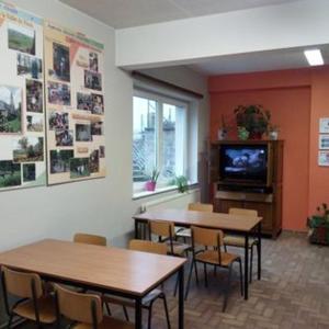 a room with tables and chairs and a tv at Centre Louis Delobbe in Olloy-sur-Viroin