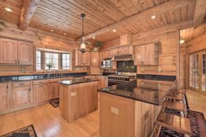 a large kitchen with wooden cabinets and a large island at Spacious House with Boat Dock on Red Cedar Lake in Mikana