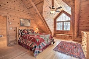 a bedroom with a bed in a log cabin at Spacious House with Boat Dock on Red Cedar Lake in Mikana