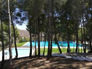 ein Pool mit Bäumen im Vordergrund in der Unterkunft Casa Pueblo Overlooking the Village of Lubrín! in Lubrín