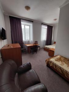 a hotel room with a couch and a table at University Hotel Tsakhkadzor in Tsaghkadzor