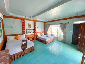 Habitación de hotel con 2 camas y ventana en Lanta Paradise Beach Resort, en Ko Lanta