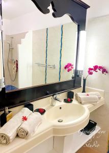 a bathroom with a sink and a large mirror at Vue Exclusive Mer et Volcan, Village Vacances avec Plage et Piscine, Les Gwadastudios in Sainte-Anne