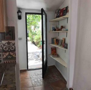 a hallway with a door to a room with bookshelves at Casa Magar Pula in Pula