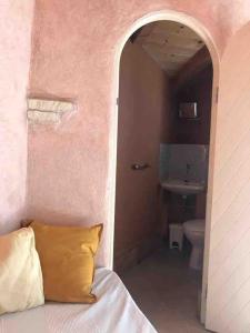 a hallway to a bathroom with a bed and a sink at Casa Magar Pula in Pula