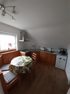 a kitchen with a table and a kitchen with a window at FeWo Zur Alten Drechslerei in Freital