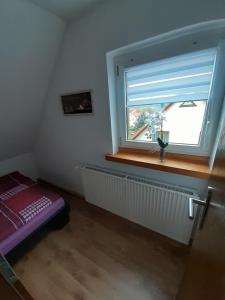 a small room with a window and a radiator at FeWo Zur Alten Drechslerei in Freital