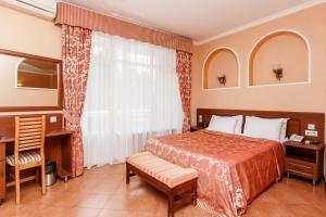 a hotel room with a bed and a window at Wind Rose Hotel & SPA in Sochi