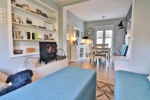 a living room with a blue couch and a fireplace at Langeooger Viermaster - Blaues Segel in Langeoog