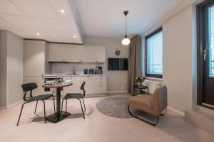 a kitchen with a table and chairs in a room at Forenom Aparthotel Tampere Kauppakatu in Tampere