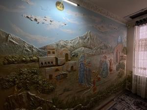 a mural on the wall of a room with mountains at Qozi Hotel in Samarkand