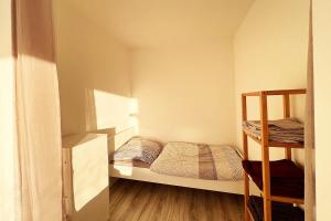 a small bedroom with a bunk bed and a ladder at Cozy apartment with balcony in Leverkusen