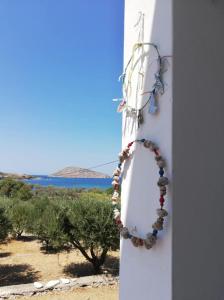 a necklace on a wall with a view of the ocean at LEROS VILLA BLEFOUTI in Alinda