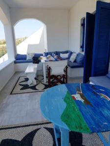 ein Wohnzimmer mit einem Tisch und einem Sofa in der Unterkunft LEROS VILLA BLEFOUTI in Alinda