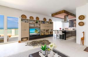 a kitchen and living room with a view of the ocean at Imani - Beachfront Penthouse with Spectacular Ocean Views in Kiwengwa