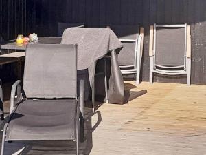 een groep stoelen en een tafel op een podium bij 5 person holiday home in Odder in Odder