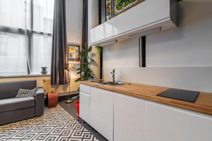 a kitchen with a sink and a counter top at Mon loft in Asnières-sur-Seine +5 photos