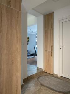 a hallway with wooden cabinets and a dining room at Kuća za odmor CAR - Tekija in Tekija