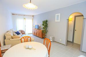 a living room with a table and a couch at Golf D 201 ONLY FAMILIES in Cambrils