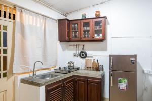 a kitchen with a sink and a refrigerator at BunkyDew in Galle +2 photos