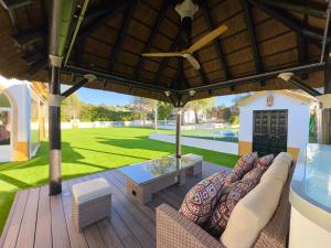 an outdoor patio with a couch and a table at VILLA MACARENA in Espera