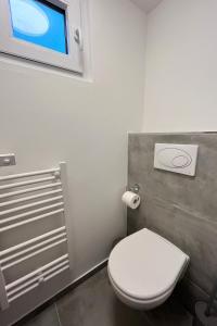 a bathroom with a white toilet and a window at Hausboot der Friesländer im Wangermeer in Wangerland +10 photos