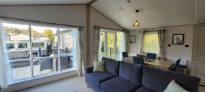 a living room with a couch and a table and a bus at Luxury Lodge @ Hoburne Devon Bay in Paignton
