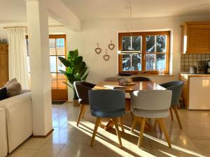 a kitchen and dining room with a table and chairs at Landhaus Obermaiselstein "THE VIEW" in Obermaiselstein