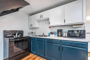a kitchen with blue appliances and white cabinets at Tidal House 5 in Ocean Shores