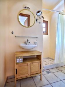 a bathroom with a sink and a mirror at Golden Beach Villa Paros in Chrissi Akti