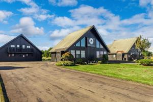 a large black barn with a driveway at Tidal House 5 in Ocean Shores