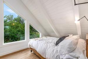 a bedroom with a bed and a large window at Tidal House 6 in Ocean Shores